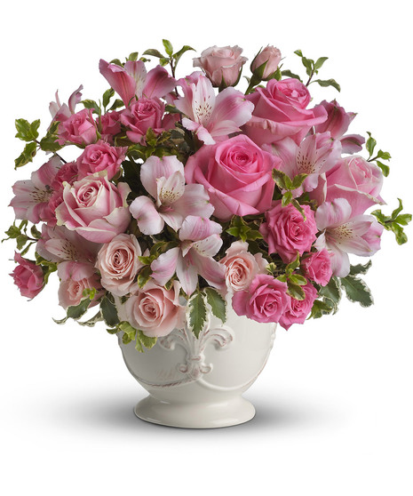 Flowes in shades of pink in a charming white container